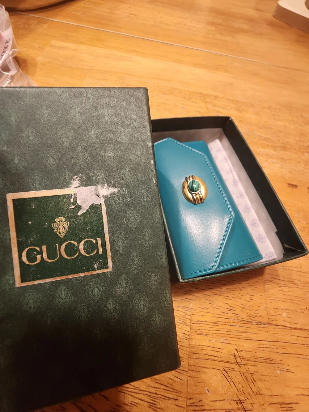 vintage Gucci teal leather key case featuring a distinctive cabochon stone